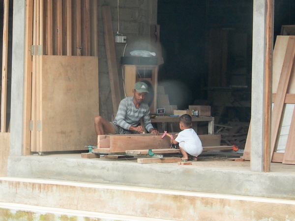 Woodworker teaching his son in Ubud