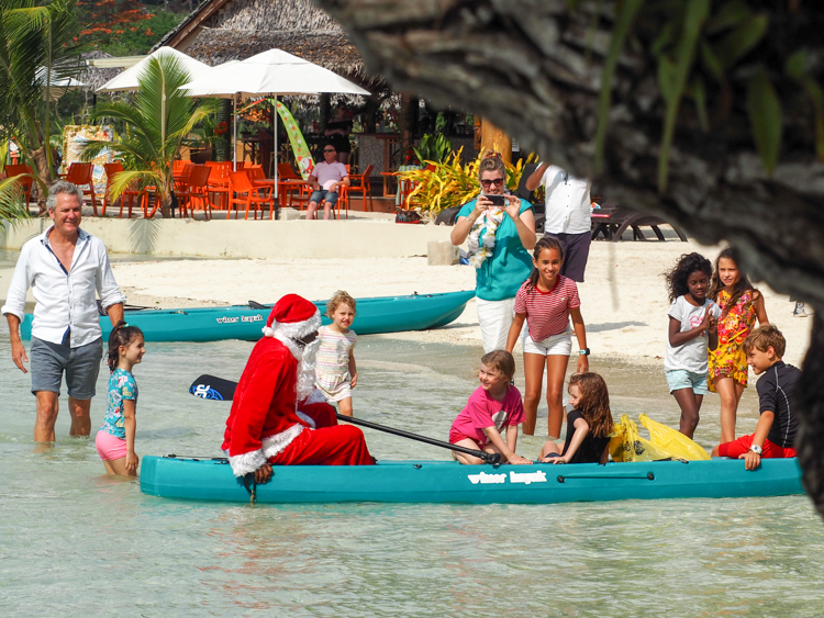Santa arrives at Erakor Island, by canoe