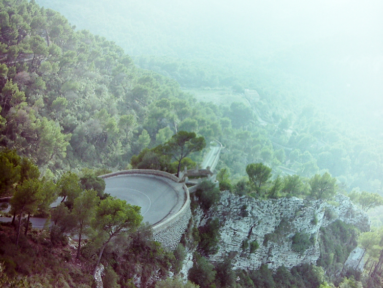 The winding road to the chapel descends into the evening mist