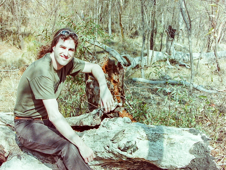 In the bush, sitting on a log that probably comprises 80% by weight venomous and deadly animals