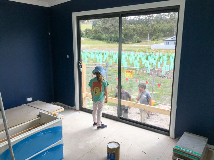 errima in the master bedroom, watching the carpenters start work on the back deck