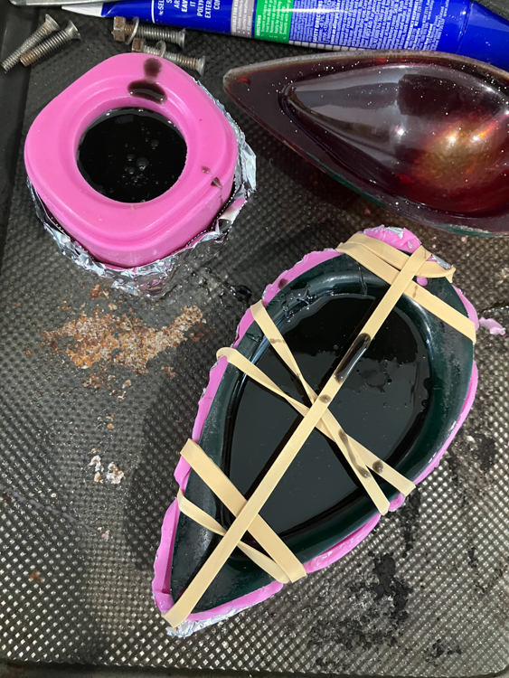 Using resin to repair the starboard lens, using the port mould as a form