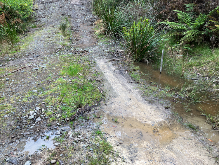 The winter creek seeping across the top of the creek crossing