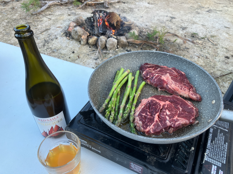 Steak, asparagus, local cider, and a fire