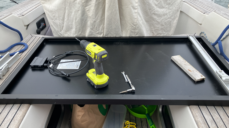 Solar panel being drilled for mounting