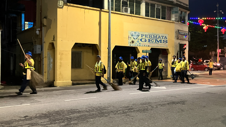 Cleaners for the Thaipusam procession